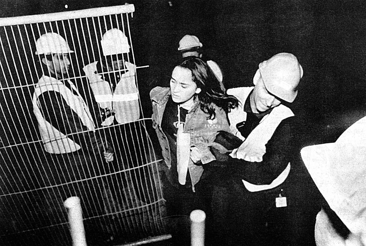 Female protester being manhandled by male security